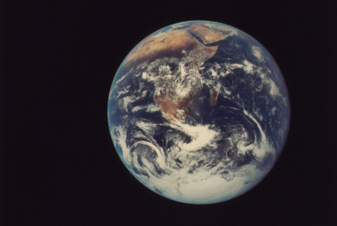 The planet earth being viewed from space, where the effects of climate change are evident.