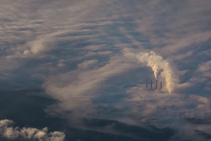 Greenhouse gases being released into Earth's atmosphere from a factory