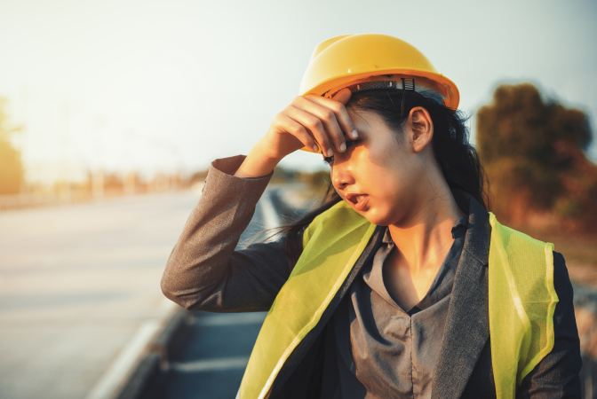A female construction worker at risk of heat stroke due to working in extreme heat