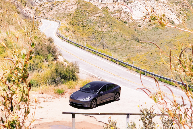 Electric vehicle parked on mountain road
