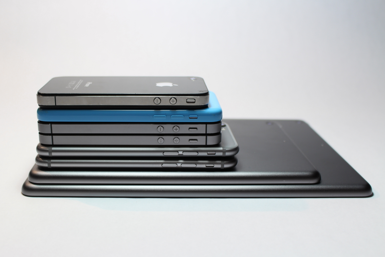 Tablets and smart phones stacked from largest to smallest