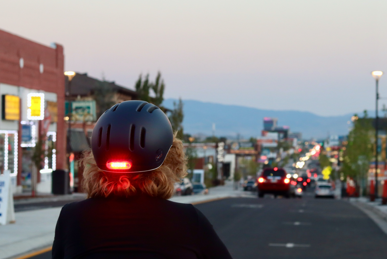 Cyclist riding down busy street with car traffic