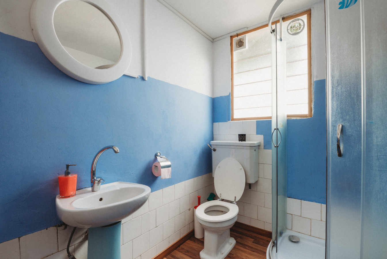 Small bathroom with blue stripe on wall