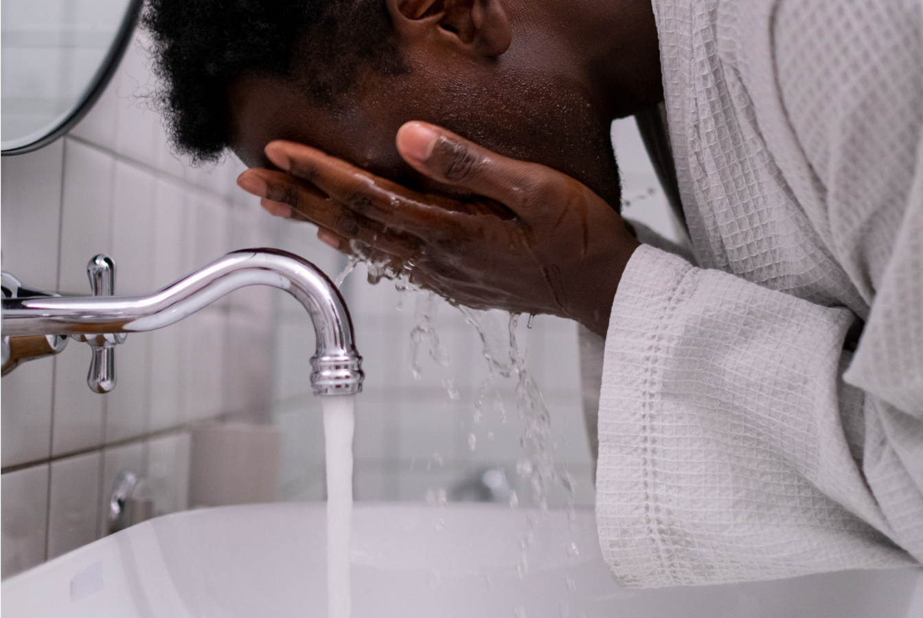 Man splashing water on his face