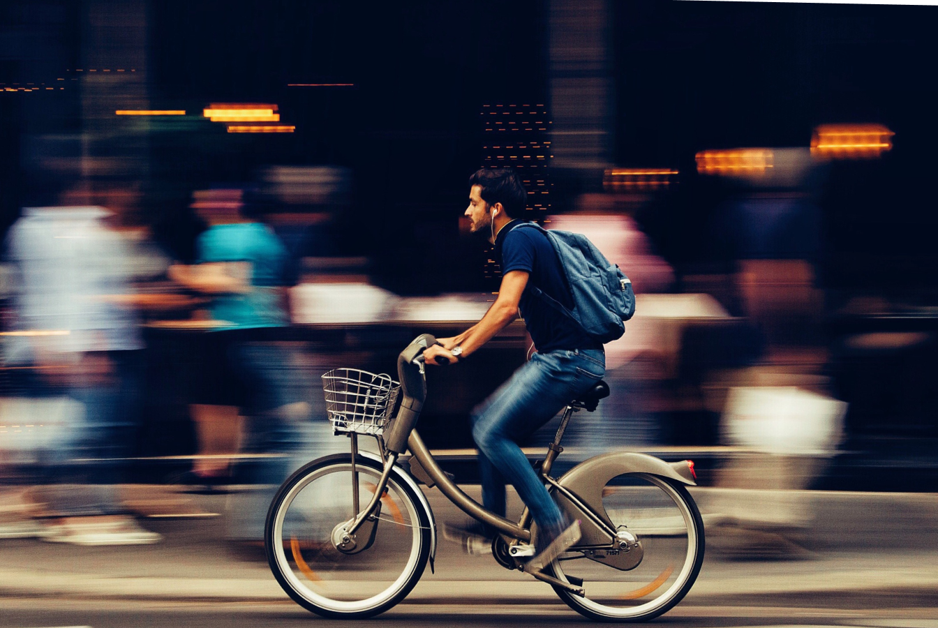 Man using an electrically assisted bicycle as an alternative to driving