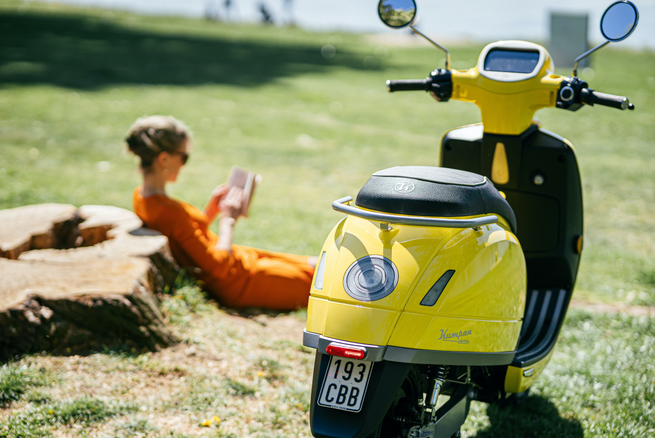 Electric scooter with woman in background