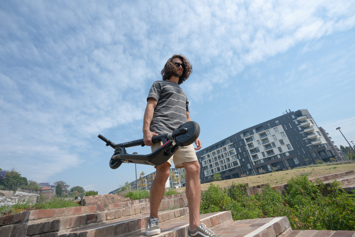 Man carrying electric standup scooter