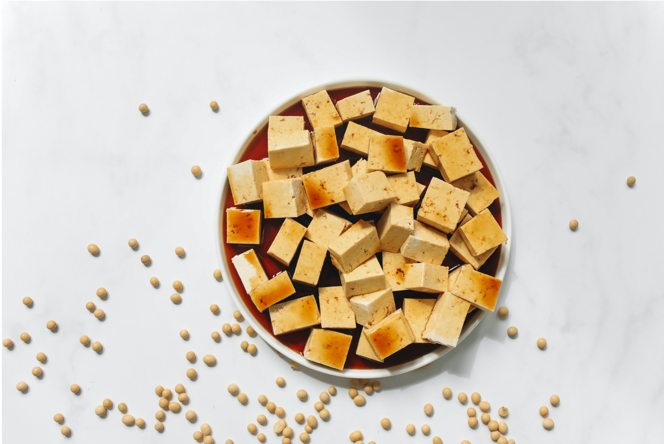 Tofu in a bowl being soaked in soy sauce for a no meat meal