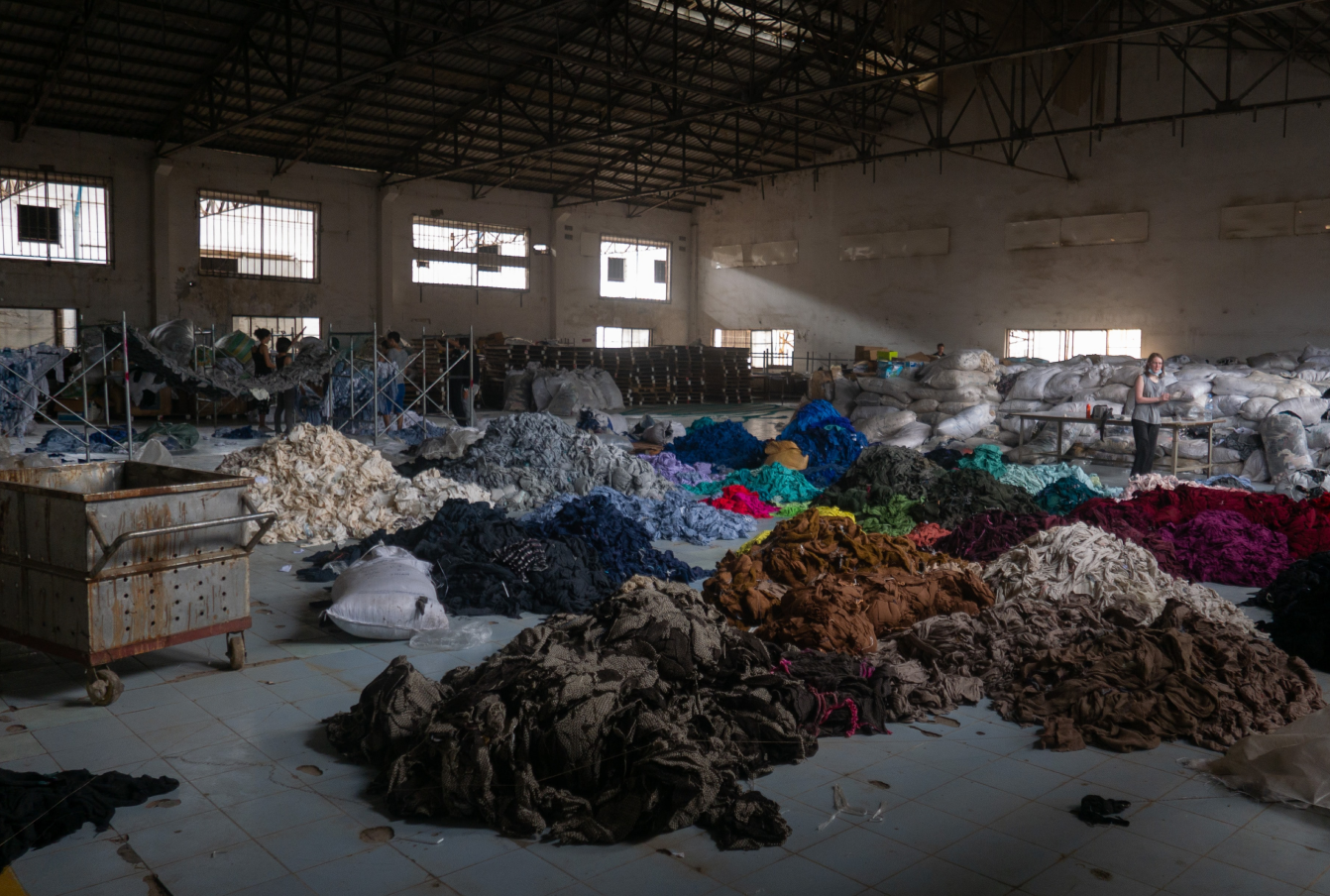 large piles of various coloured fabric