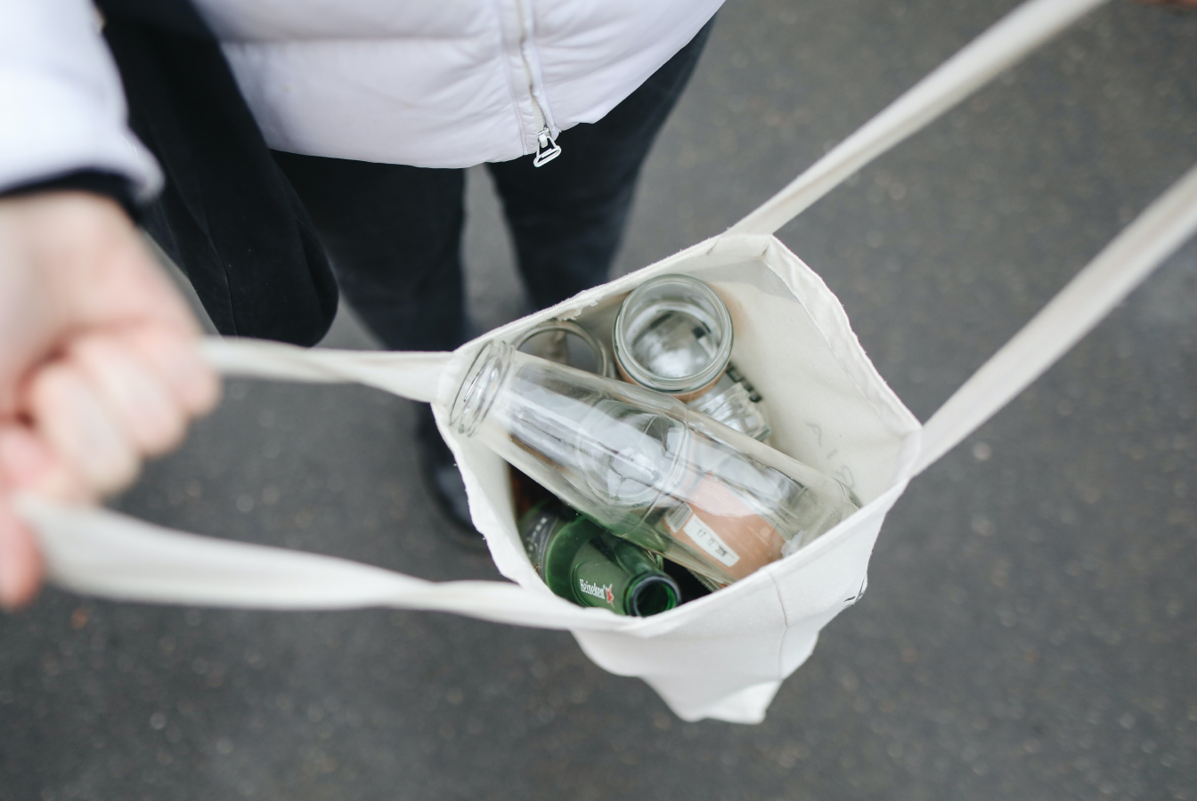 Hands opening bag of glass bottles