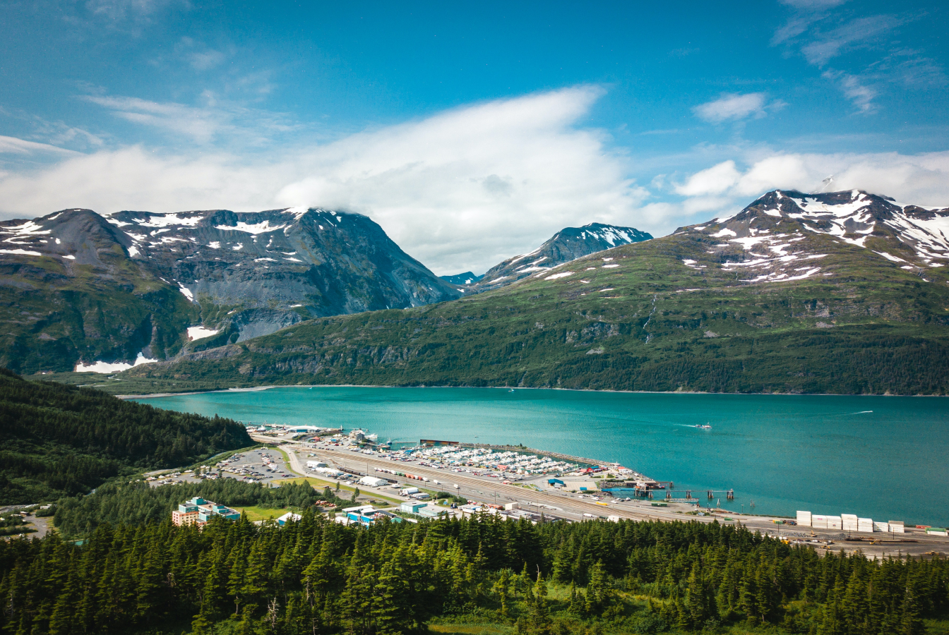 Aerial view lakeside town with mountains behind