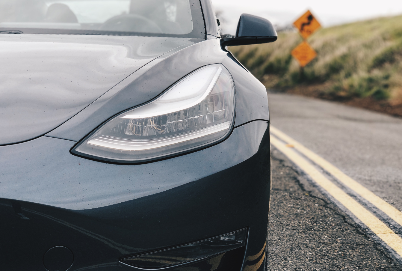 A Picture Of An Tesla Electric Car On A Deserted Road In Norway