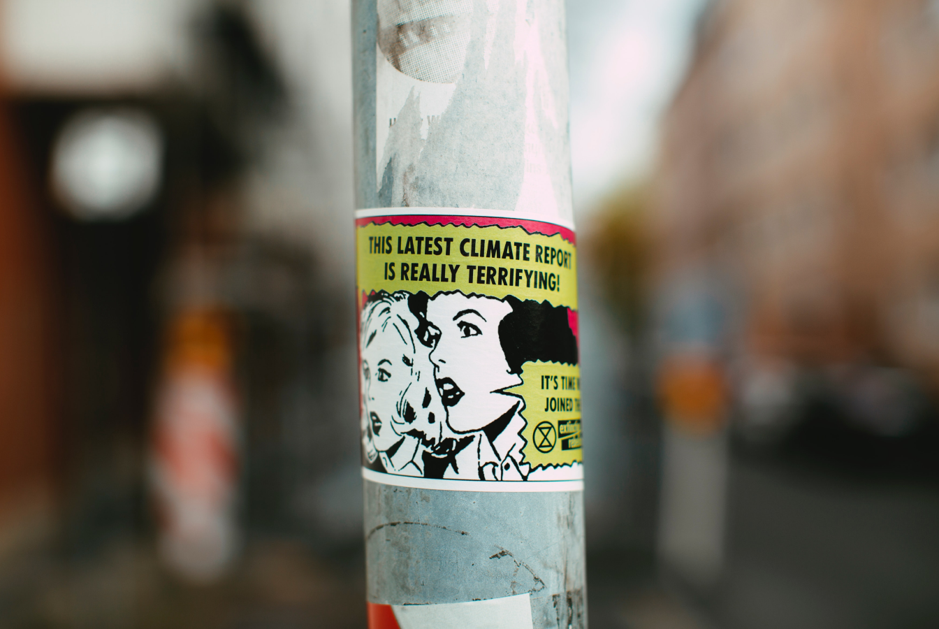 A sticker from a protest that reads "This latest climate report is really terrifying!"