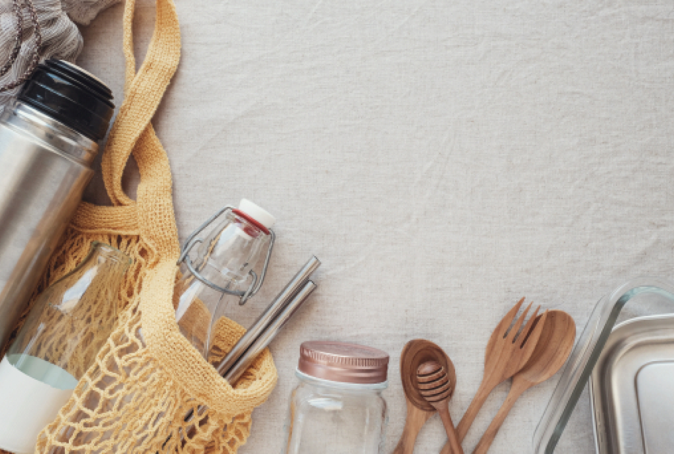 Plastic-free alternatives like wooden cutlery, metal straws, glass bottles and a coffee thermos.