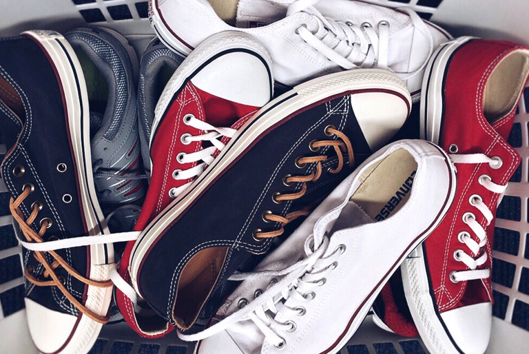 A pile of different colour sneakers