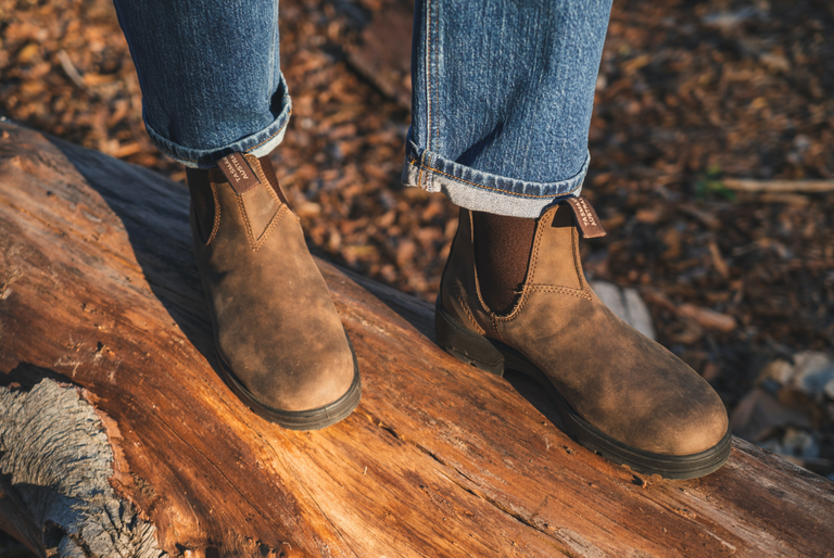 A person wears a pair of hard-wearing leather boots