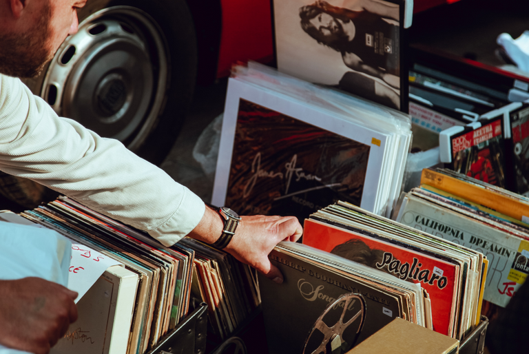 A person goes through a box of secondhand and vintage vinyl records