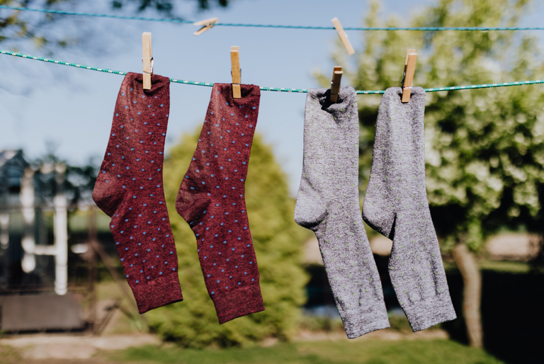 Socks hang on a laundry line to dry