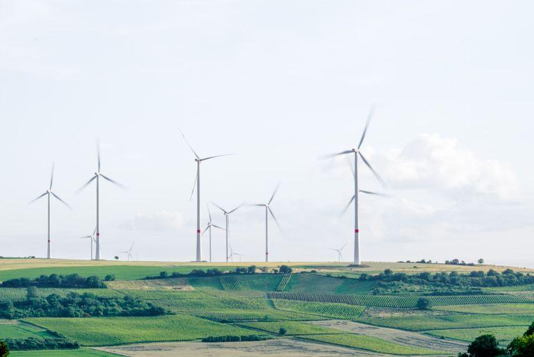 Several large wind turbines helping reduce greenhouse gas emissions and air contaminants