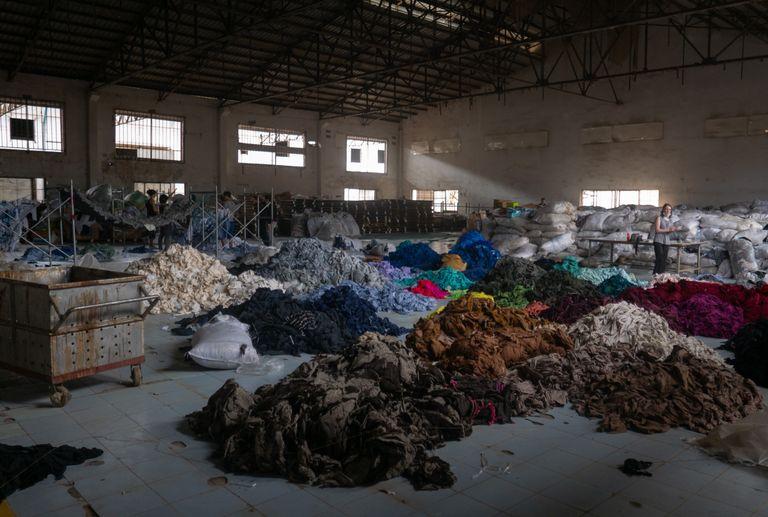 Fast fashion clothing being recycled in a warehouse