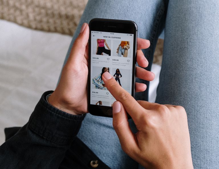 A girl buying vintage clothing online with mobile device
