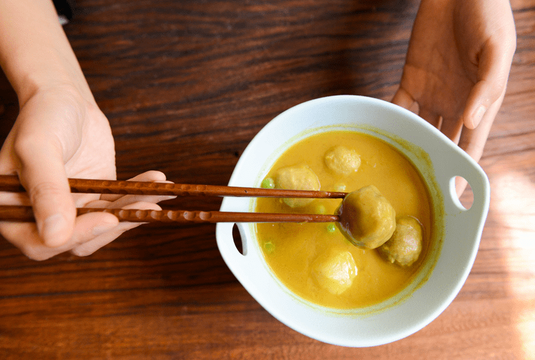 Vegan soup eaten with chopsticks