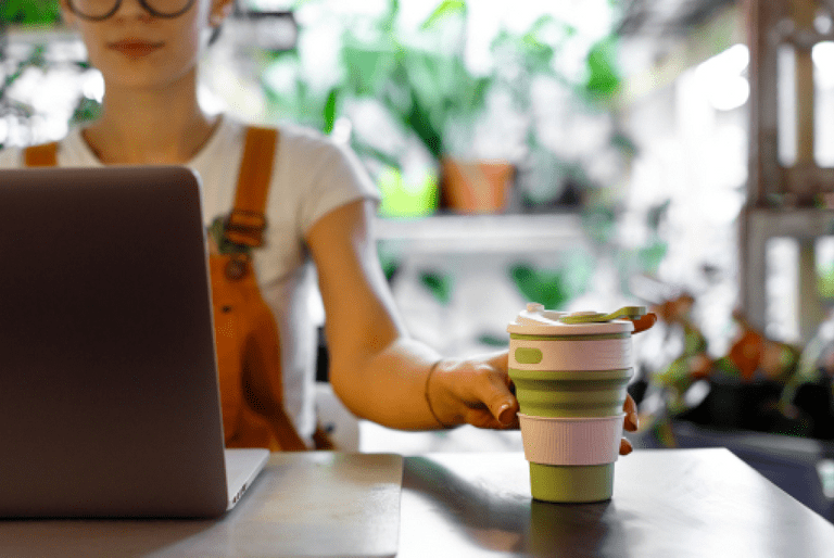 women with coffee in reusable mug