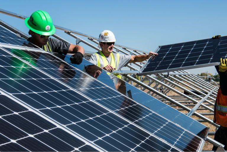 workers installing solar panels