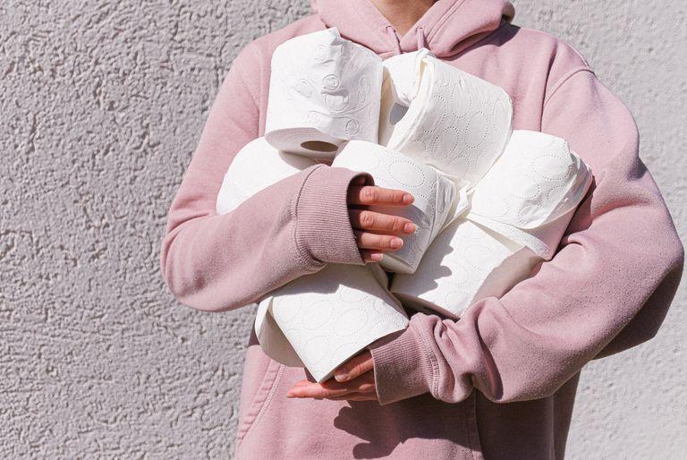 A person hoarding rolls of toilet paper during the coronavirus pandemic.