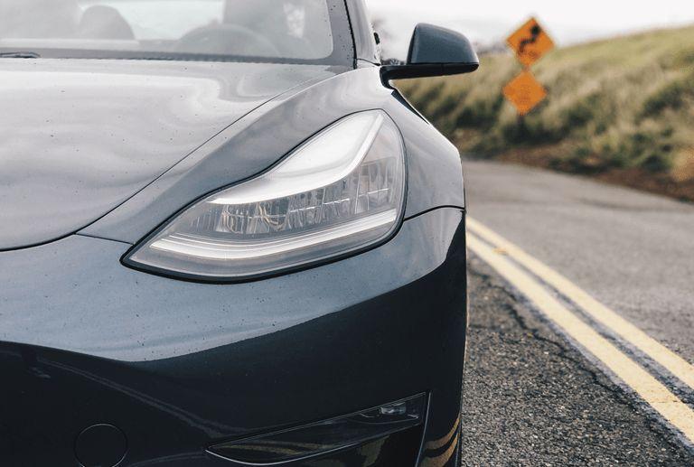 A Picture Of A Tesla Electric Car On A Deserted Road In Norway