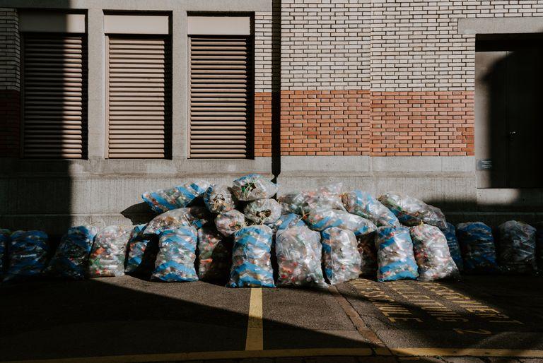 A large pile of clear plastic bags filled with recycling.