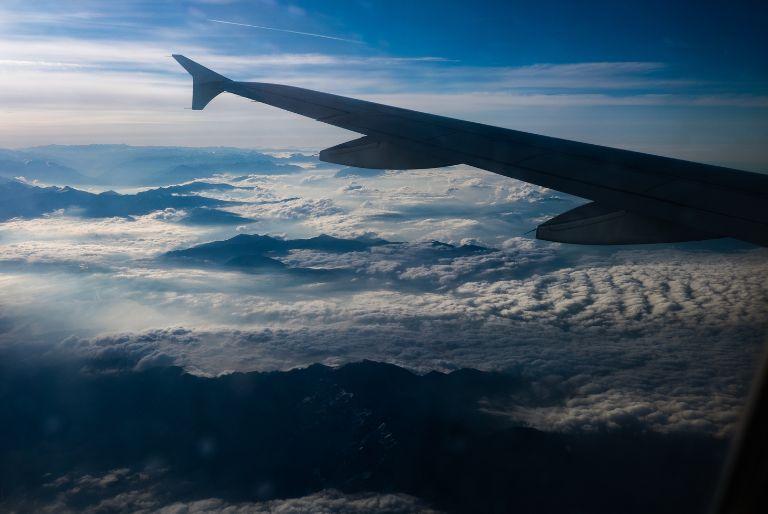 A view of mountains from the window of a plane.