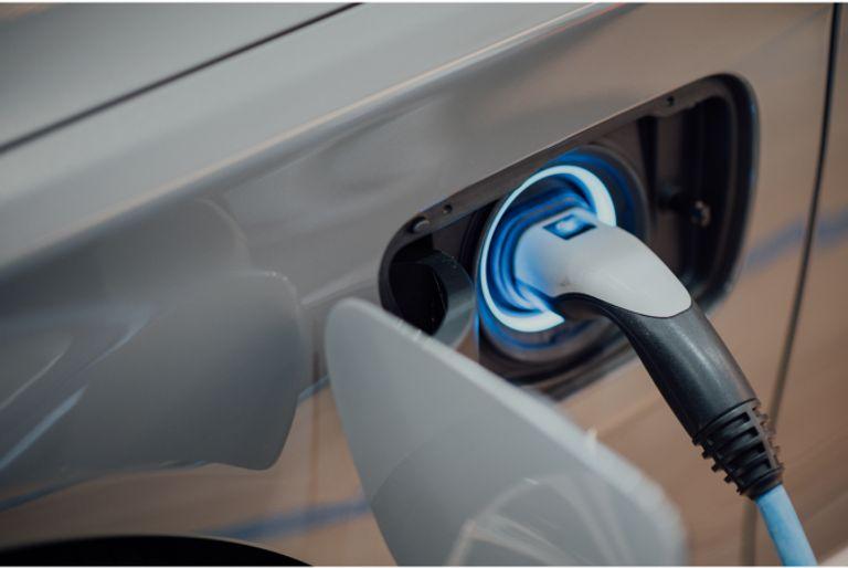 A closeup of an electric car charging station, which was funded by a carbon offset project