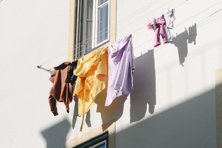Someone reducing their carbon footprint by airdrying their clothes on a clothes line