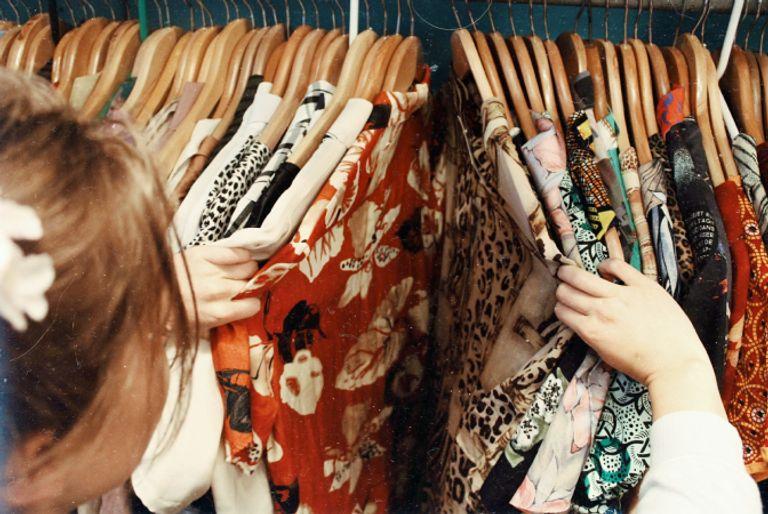 A girl shopping for new clothes which will increase her carbon footprint.