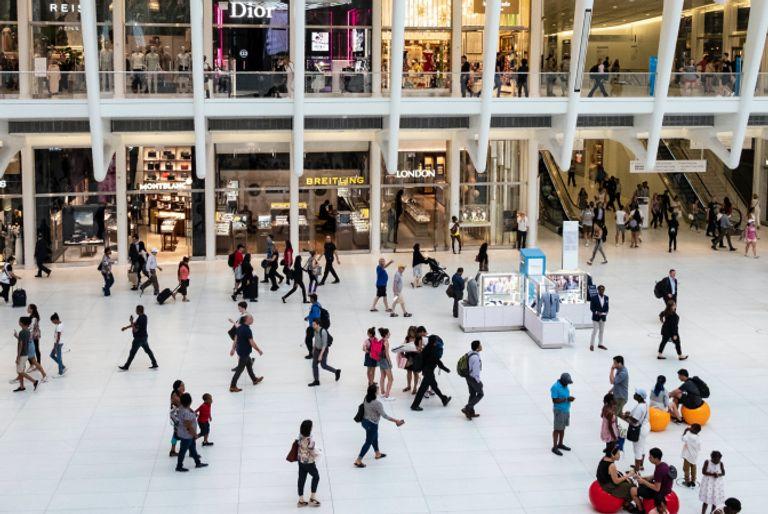 A busy mall full of people buying items that will contribute to their carbon footprint.