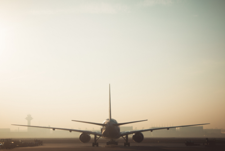 An airplane sits on the runway at an airport