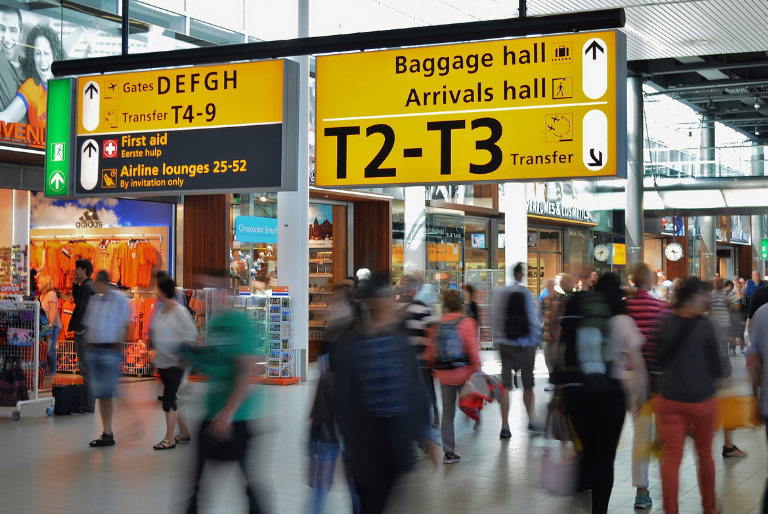 People walk through an airport terminal