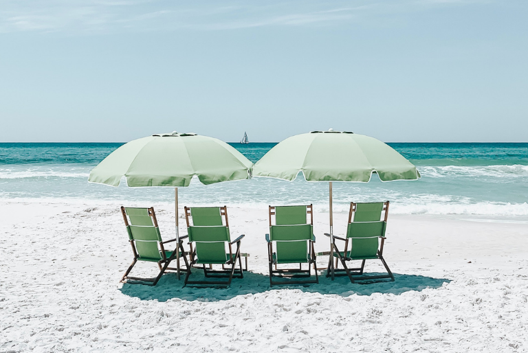 Beach chairs under umbrellas on a sunny beach