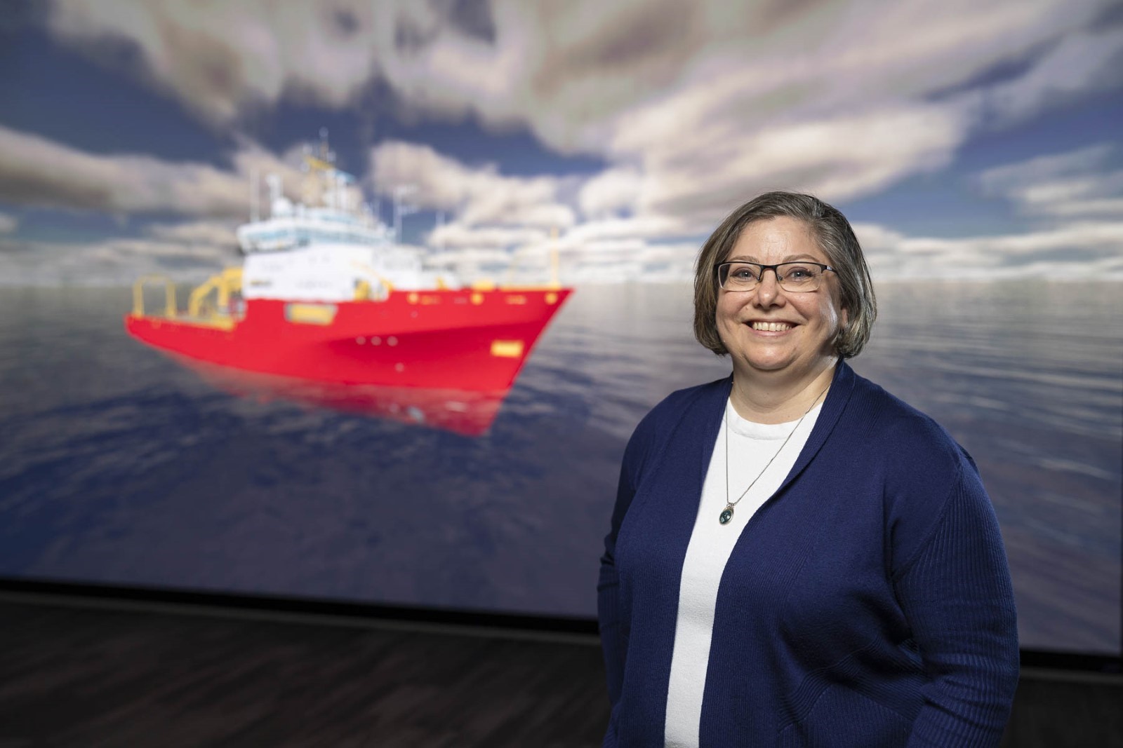Jennifer Busler, Innovation Manager, Seaspan Shipyards in front of the HoloShip powerwall.