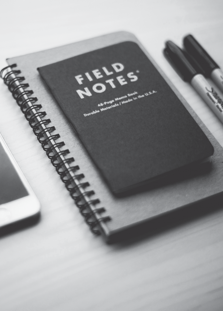 A notebook with the title field notes written on it