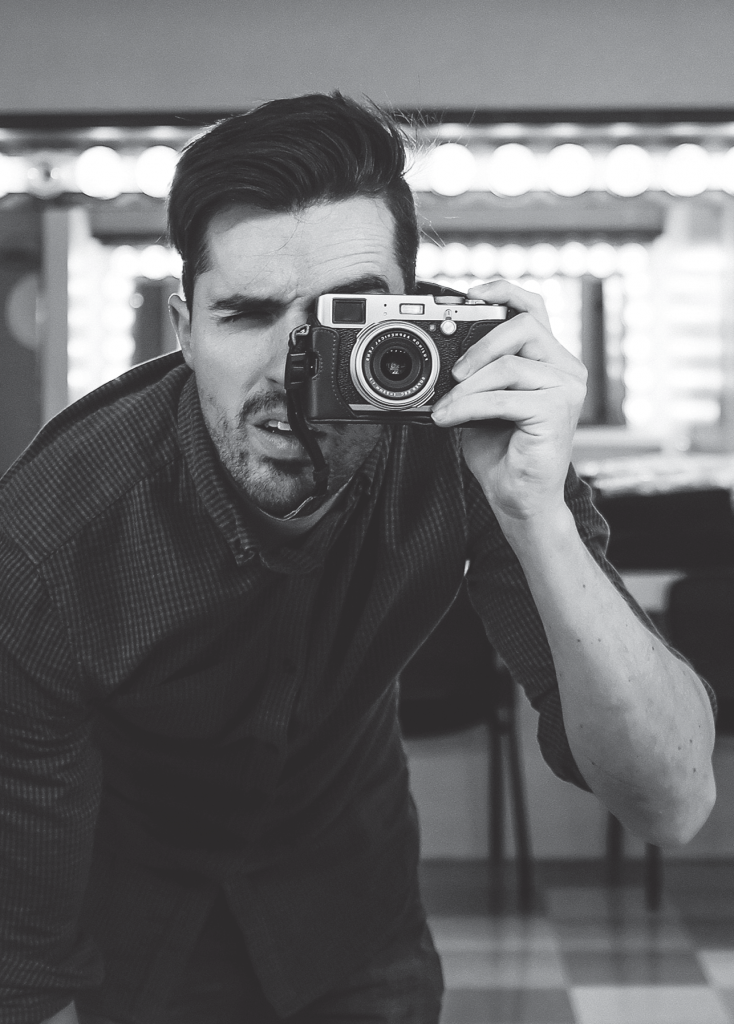 A picture of a guy looking through a camera