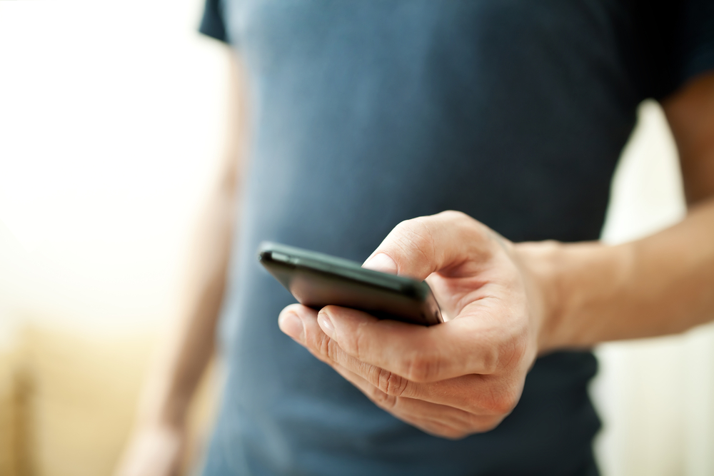 A person holding a smartphone in his or her hand