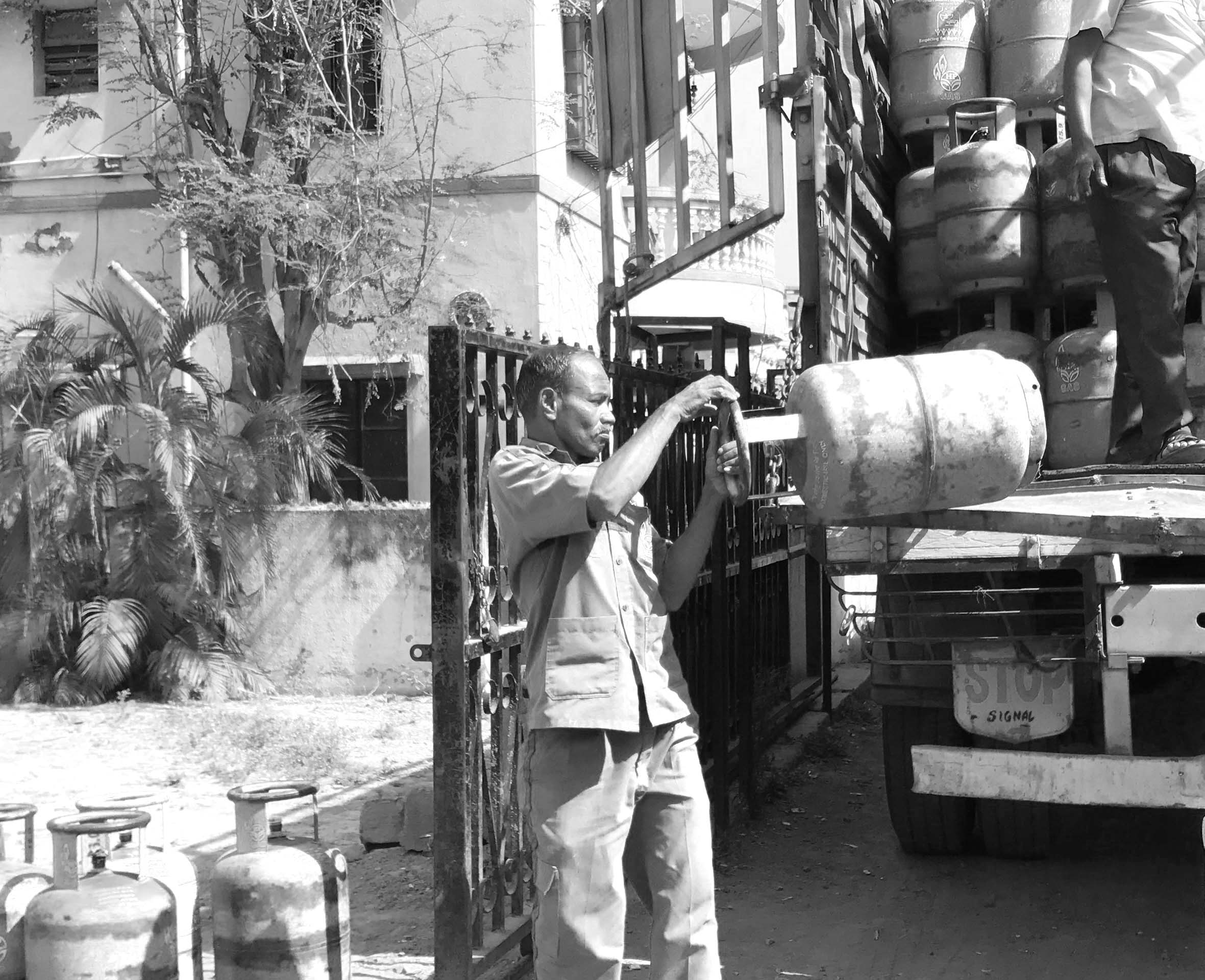 a man taking a cylinder from a truck