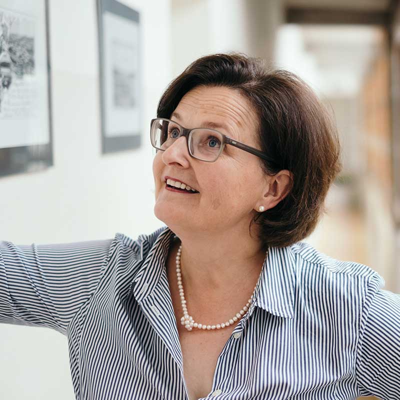 Portrait of Sylvia Prunthller smiling at something above her to the right.