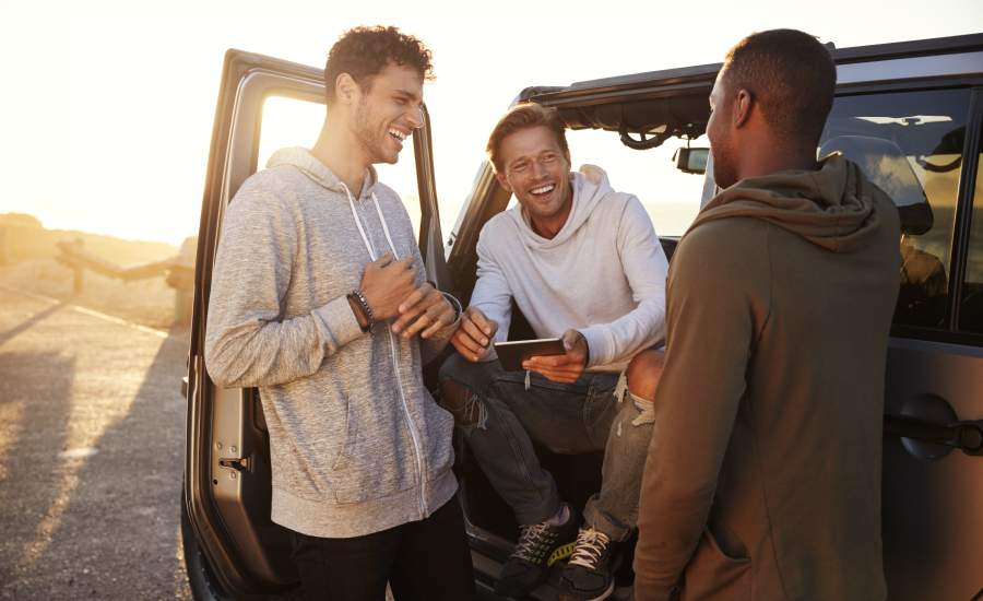 Men laughing in car