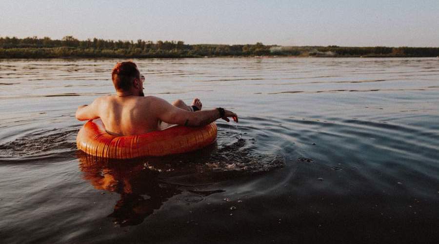 man floating in an inner tube