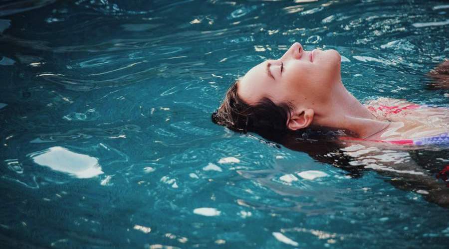 girl floating in jacobs well
