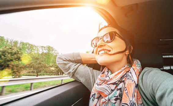 girl laughing out car window