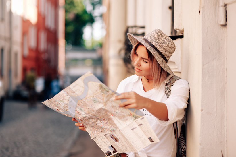 solo traveler looking at map